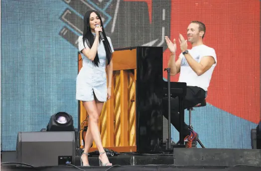  ?? Jemal Countess / Getty Images for Global Citizen Festival: Mandela 100 ?? Kacey Musgraves, here with Chris Martin, comes to the Masonic in San Francisco on Feb. 16.