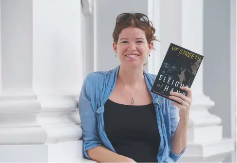  ?? Picture: STEWART McLEAN ?? PUBLISHED: Suspense writer Shawna Coleing, aka V F Streets, with her debut novel, Sleight of Hand.