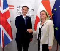  ?? AFP ?? Britain’s Foreign Minister Jeremy Hunt shakes hands with Austria’s Foreign Minister Karin Kneissl in Vienna on Wednesday. —