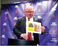  ?? NWA Democrat-Gazette/CHARLIE KAIJO ?? Rogers Police Chief Hayes Minor holds up a picture of Grant Hardin, a suspect in a cold case, during a press conference Monday at the Rogers Police Station in Rogers. Hardin was arrested Monday in connection with the 1997 rape of a Rogers school teacher.