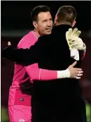  ?? ?? Jon McLaughlin and Michael Beale share a hug in celebratio­n,