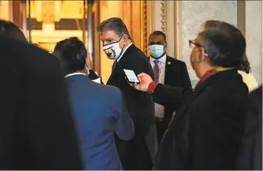  ?? Anna Moneymaker / New York Times ?? Reporters at the Capitol trail Sen. Joe Manchin, DW.Va., a key figure in the debate over a virus relief bill.