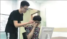 ?? PHOTOS BY GAO ERQIANG / CHINA DAILY ?? From left: Cai Dongyue, 26, who was born blind, tests smart glasses made by NextVPU, a vision-processing chipmaker in Shanghai. The glasses have two small cameras that capture images just like the eyes and transfer them to a minicomput­er with a visual-recognitio­n program and an image database of more than 3 million pictures.