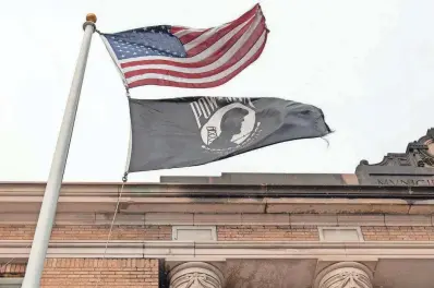  ?? RICK CINCLAIR/TELEGRAM & GAZETTE ?? The American flag and the POW/MIA flag fly Wednesday in front of Leominster City Hall. The Commonweal­th of Massachuse­tts flag is on a nearby pole.