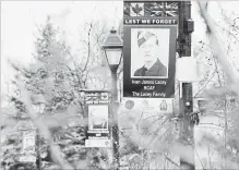 ?? PETER LEE WATERLOO REGION RECORD ?? Banners rememberin­g, from foreground right, Ivan James Lacey, Frederick Roy Stewart and Donald MacKenzie Beattie hang from light posts on Tannery Street in the Hespeler area of Cambridge.
