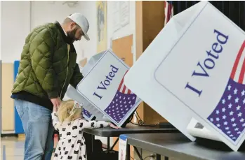  ?? CAROLINE GUTMAN/THE NEW YORK TIMES ?? A voter casts his ballot in the GOP presidenti­al primary Saturday in Charleston, S.C.