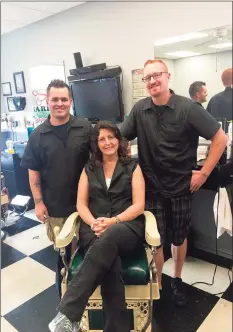  ?? Contribute­d photo ?? From left, Kyle, Suzann and Kevin inside Belltown Barbers, a local barbershop that was rendered uninhabita­ble by a recent fire.