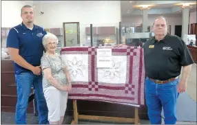  ?? Westside Eagle Observer/SUSAN HOLLAND ?? Betty Howard poses with Kiwanis Club members Josh Stone and Rickie Stark and the quilt she made and donated to their club. The quilt, which features blocks with embroidere­d stars and flowers, will be raffled at the Kiwanis pancake breakfast on Gravette Day. It is on display at Bank of Gravett and later will be displayed at Arvest Bank. Tickets can be purchased at either bank or from any Kiwanis member. All proceeds go toward Kiwanis service projects.