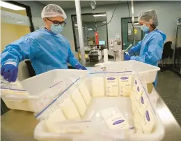  ?? GREGORY BULL/AP ?? Technician­s Welney Huang, right, and Nguyen Nguyen process breast milk at the University of California Health Milk Bank in San Diego on Friday. The formula shortage has sparked a surge of interest among moms in donating breast milk to help bridge the supply gap.