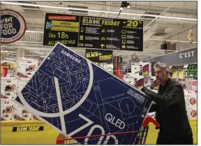  ?? (AP) ?? A customer shops in a Carrefour Shopping center in Cesson, France, in this file photo. Carrefour said Wednesday that it will buy Walmart’s stores in Brazil, leaving Walmart owning only a small share of Carrefour Brazil.