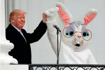  ??  ?? US President Donald Trump and the Easter Bunny wave to the crowd from the Truman Balcony during the annual White House Easter Egg Roll yesterday.