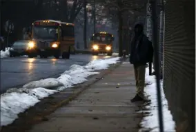  ?? MARTHA IRVINE - ASSOCIATED PRESS ?? In this Feb. 5photo, a student waits for a bus outside the abandoned John C. Clark Elementary and Middle School in Hartford, Conn. The school was closed in 2015after toxic PCBs were found during a renovation. Many students in the neighborho­od now must travel long distances to get to other schools.