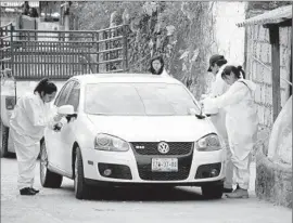  ?? Tony Rivera
Associated Press ?? A CAR is dusted for prints outside the home where Gisela Mota was killed in Pueblo Viejo, near Temixco. Three suspects were arrested.