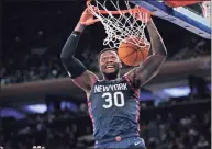  ?? Seth Wenig / Associated Press ?? New York Knicks’ Julius Randle dunks the ball during the second half against the Miami Heat on Jan. 12 in New York. Randle has been impressed by new coach Tom Thibodeau’s attention to detail.