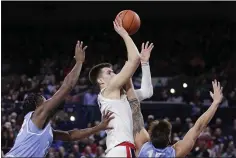  ?? YOUNG KWAK — THE ASSOCIATED PRESS ?? Gonzaga’s Filip Petrusev rises and shoots between two San Diego defenders in Thursday’s win over the Toreros.