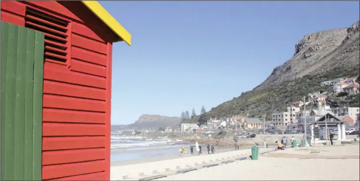  ?? Surfer’s Corner, with the Muizenberg station behind it, is one of South Africa’s most famous and popular surf spots, especially for beginners. PICTURES: KIM STONE ??