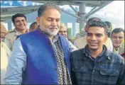  ?? HT PHOTO ?? Vikas (right) being welcomed by Haryana education minister Ram Bilas Sharma at the IGI airport in Delhi.