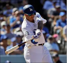  ??  ?? Los Angeles Dodgers’ Manny Machado drives in a run with a single against the San Diego Padres during the fourth inning of a baseball game on Sunday in Los Angeles. AP Photo/MArcIo JoSe SAnchez