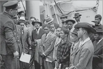  ??  ?? Jamaican immigrants on the Empire Windrush are welcomed by RAF officials