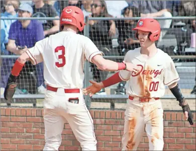  ?? Jeremy Stewart ?? Cedartown’s Ace Allen (right) celebrates with teammate Dylan Cupp after both players scored in the third inning against North Atlanta at Cedartown High School on Monday, Feb. 20. The Bulldogs won 8-3.