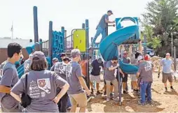  ??  ?? Kaboom, a nonprofit organizati­on, coordinate­s the building of a playground at North Bend Elementary School in southwest Baltimore.