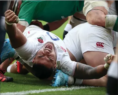  ??  ?? Manu Tuilagi celebrates England’s third try during their demolition of Ireland yesterday