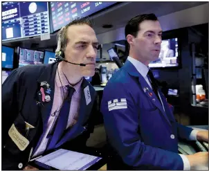  ?? AP/RICHARD DREW ?? Trader Gregory Rowe (left) and specialist John McNierney work Tuesday on the floor of the New York Stock Exchange. Tuesday was a down day for stocks.