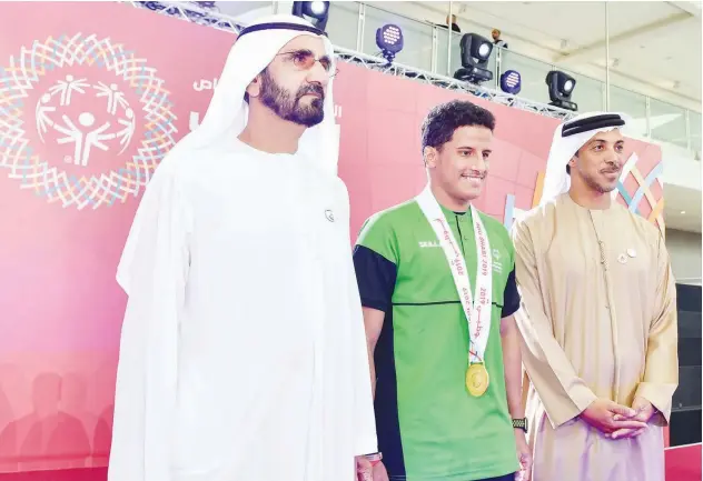  ?? WAM ?? Sheikh Mohammed honours Saudi Arabian athlete Hassan Al Hadraki who won the gold medal in the athletics competitio­n at the Special Olympics World Games.