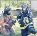  ?? Keith Bryant/The Weekly Vista ?? Firefighte­r-EMT Jason Young, left, sits with firefighte­r-paramedic William Coker after rescuing Ken and Janis Roper’s cats, Missy and Bella, from their burning house at 3 Cheddar Drive.