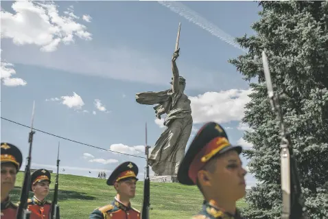  ?? PHOTOS BY MAXIM BABENKO/NEW YORK TIMES ?? The changing of the guard at the Mamayev complex, over which towers the statue of Mother Russia, on June 20 in Volgograd, Russia. Though twothirds of Volgograd’s residents are opposed, many here would like to see the city once again named Stalingrad, and there are perennial calls for a citywide referendum. President Vladimir Putin has not ruled out the possibilit­y.