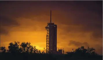  ?? BILL INGALLS — NASA VIA AP ?? A SpaceX Falcon 9 rocket with the company’s Crew Dragon spacecraft onboard is seen on the launch pad as preparatio­ns continue for today’s expected launch at NASA’s Kennedy Space Center in Cape Canaveral, Fla.