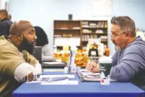  ?? STAFF PHOTO BY C.B. SCHMELTER ?? Terrence Jackson, left, talks with Ronald VanHoozier, the human resources director/corporate trainer for Chattanoog­a Goodwill Industries Inc., during a job fair at the Silverdale Detention Center on Wednesday.