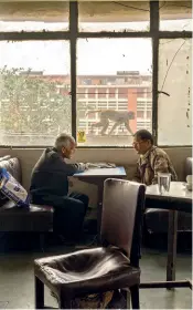  ??  ?? Men sit and talk in the Indian Coffee House, Baba Kharak Singh Marg, New Delhi, 2010