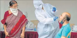  ??  ?? A health worker takes a swab sample of a resident in Malad on Wednesday.