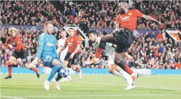  ??  ?? Manchester United’s Romelu Lukaku (right) in action with Valencia’s Neto during the Champions League group H match at Old Trafford in Manchester, north west England. — Reuters photo