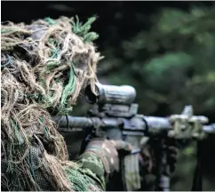  ??  ?? CPL JAY EKIN / OPERATION REASSURANC­E LAND TASK FORCE IMAGERY TECHNICIAN A member of the sniper team watches for the enemy during Operation REASSURANC­E last October.