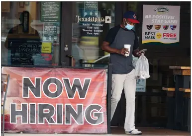  ?? (AP/LM Otero) ?? A customer exits a restaurant Wednesday in Richardson, Texas, that is seeking new employees. The number of Americans applying for unemployme­nt benefits fell last week, the Labor Department reported.