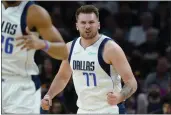  ?? MATT YORK — THE ASSOCIATED PRESS ?? Dallas Mavericks guard Luka Doncic celebrates a basket against the Phoenix Suns during the first half Sunday.