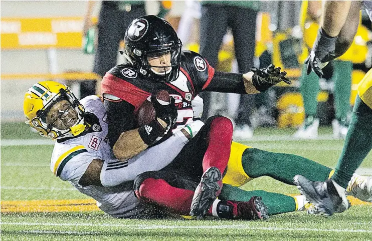  ?? — WAYNE CUDDINGTON/POSTMEDIA NEWS ?? Ottawa QB Trevor Harris is hauled down as the Redblacks take on the Eskimos at TD Place in Ottawa on Thursday. The Esks won 27-20