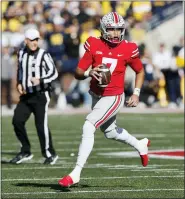  ?? JAY LAPRETE — THE ASSOCIATED PRESS ?? Ohio State quarterbac­k C.J. Stroud looks for an open pass against Michigan during the first half of a game last month in Columbus, Ohio.