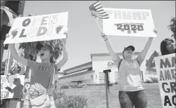  ?? BEA AHBECK/NEWS-SENTINEL ?? Vanessa Valle and Breanna Marino, both of Lodi, support the Open Lodi protest in Lodi on Saturday.