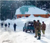  ?? AFP ?? Security staff stand near the gondola at Gulmarg in Kashmir. —