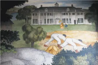  ?? Yalonda M. James / The Chronicle ?? A portion of the “Life of Washington” mural at George Washington High School depicts black slaves working on a plantation. The San Francisco school board has voted to destroy the fresco.