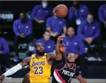 ?? ASHLEY LANDIS ?? Los Angeles Lakers forward Lebron James (23) and Portland Trail Blazers guard CJ Mccollum (3) battle for possession during the second half of an NBA basketball game Tuesday, Aug. 18, 2020, in Lake Buena Vista, Fla.