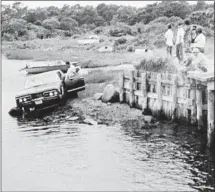  ?? Associated Press ?? KENNEDY’S car is pulled out of the water July 19, 1969, in Edgartown, Mass. Mary Jo Kopechne’s body was found inside.