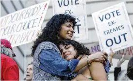  ?? AP ?? Mitzi Rivas hugs her daughter Maya Iribarren during an abortion-rights protest in San Francisco on Friday. The U.S. Supreme Court’s decision Friday to end constituti­onal protection for abortion opened the gates for a wave of litigation from all sides.