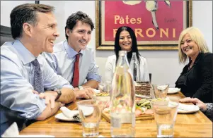  ?? NATHAN DENETTE/THE CANADIAN PRESS ?? From left, Finance Minister Bill Morneau, Prime Minister Justin Trudeau and Small Business and Tourism Minister Bardish Chagger chat over lunch with the owners of family-run restaurant, Pastaggio Italian Eatery, in Whitchurch­Stouffvill­e, Ont., on Monday.
