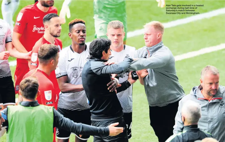  ??  ?? Alan Tate gets involved in a heated exchange during half-time of Saturday’s match between Swansea City and Birmingham.