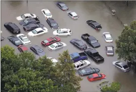  ?? THE ASSOCIATED PRESS ?? Cars are flooded near the Addicks Reservoir as floodwater­s from Tropical Storm Harvey rise in Houston Tens of thousands of personal vehicles were inundated by floodwater­s or smashed by wind-tossed objects.
