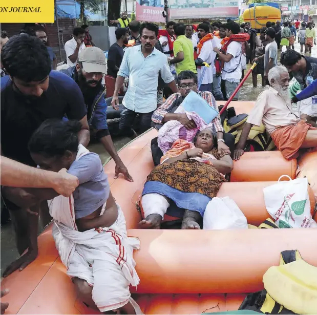  ?? AFP / GETTY IMAGES ?? Indian residents are evacuated by rescue workers in Paravoor in the south Indian state of Kerala on Sunday, as the region recovers from substantia­l flooding. Rescuers waded into submerged villages in a search for survivors cut off for days by floods that have already killed more than 350 people.